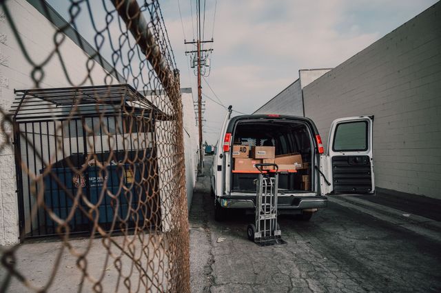People loading boxes into a moving van