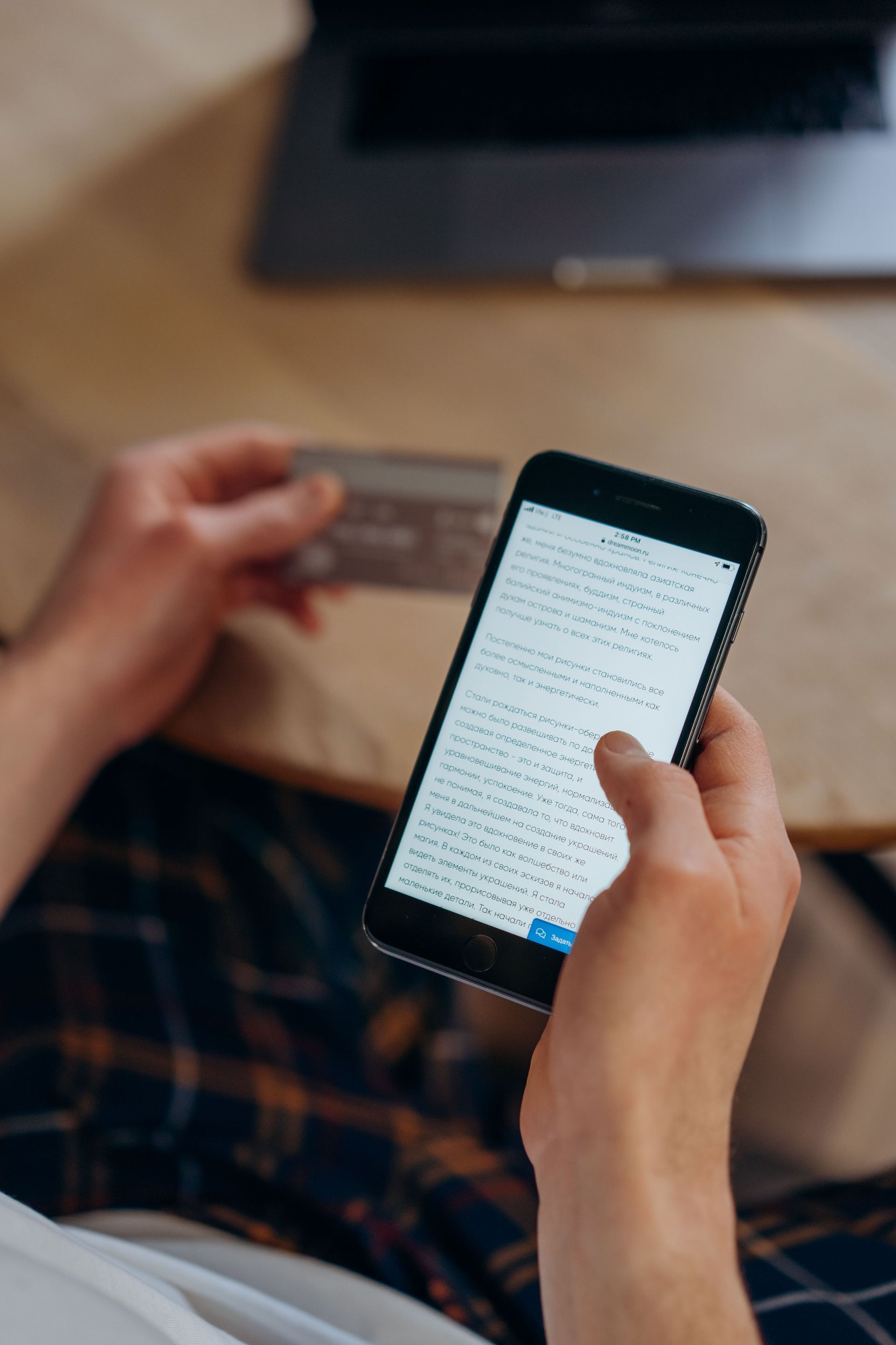 Hand holding a smartphone to rent a storage unit online
