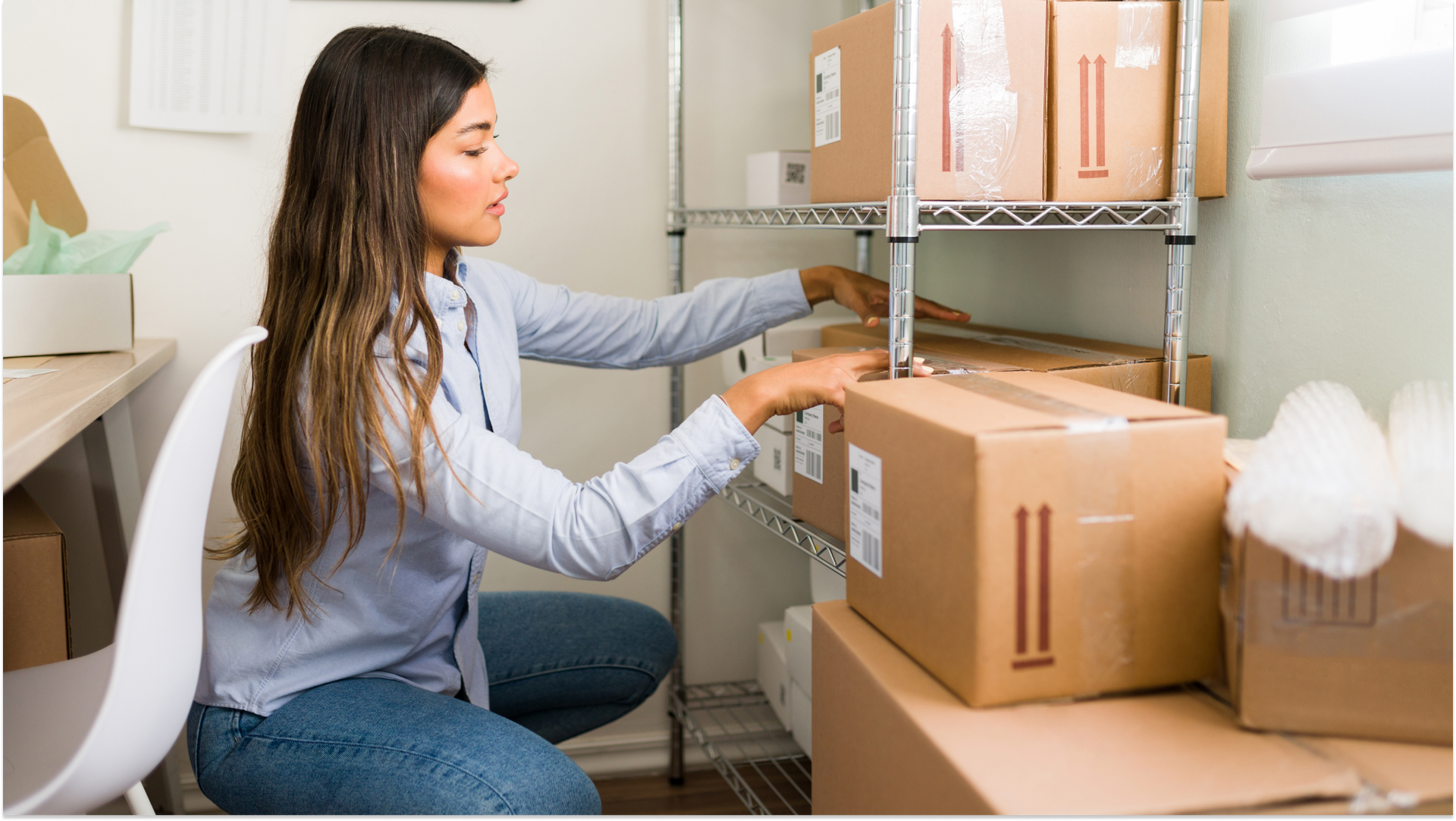 woman kneeling in office looking at storage boxes