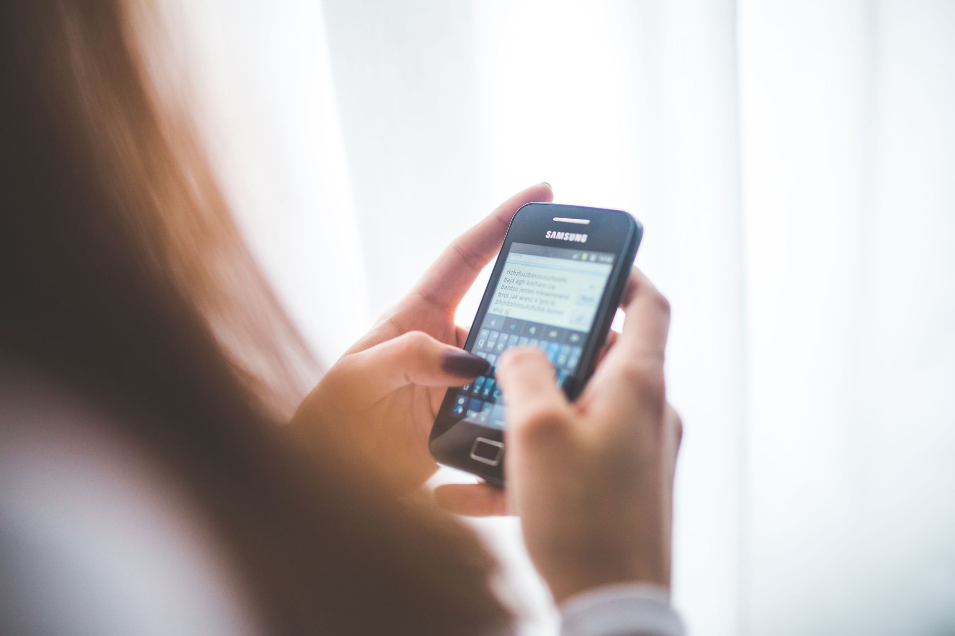 Person reading a text message on a smartphone