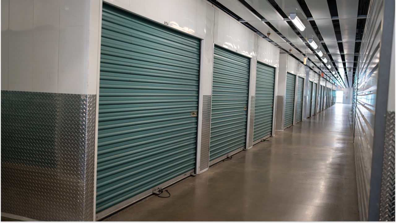 Rows of storage unit doors inside a Storage Outlet facility