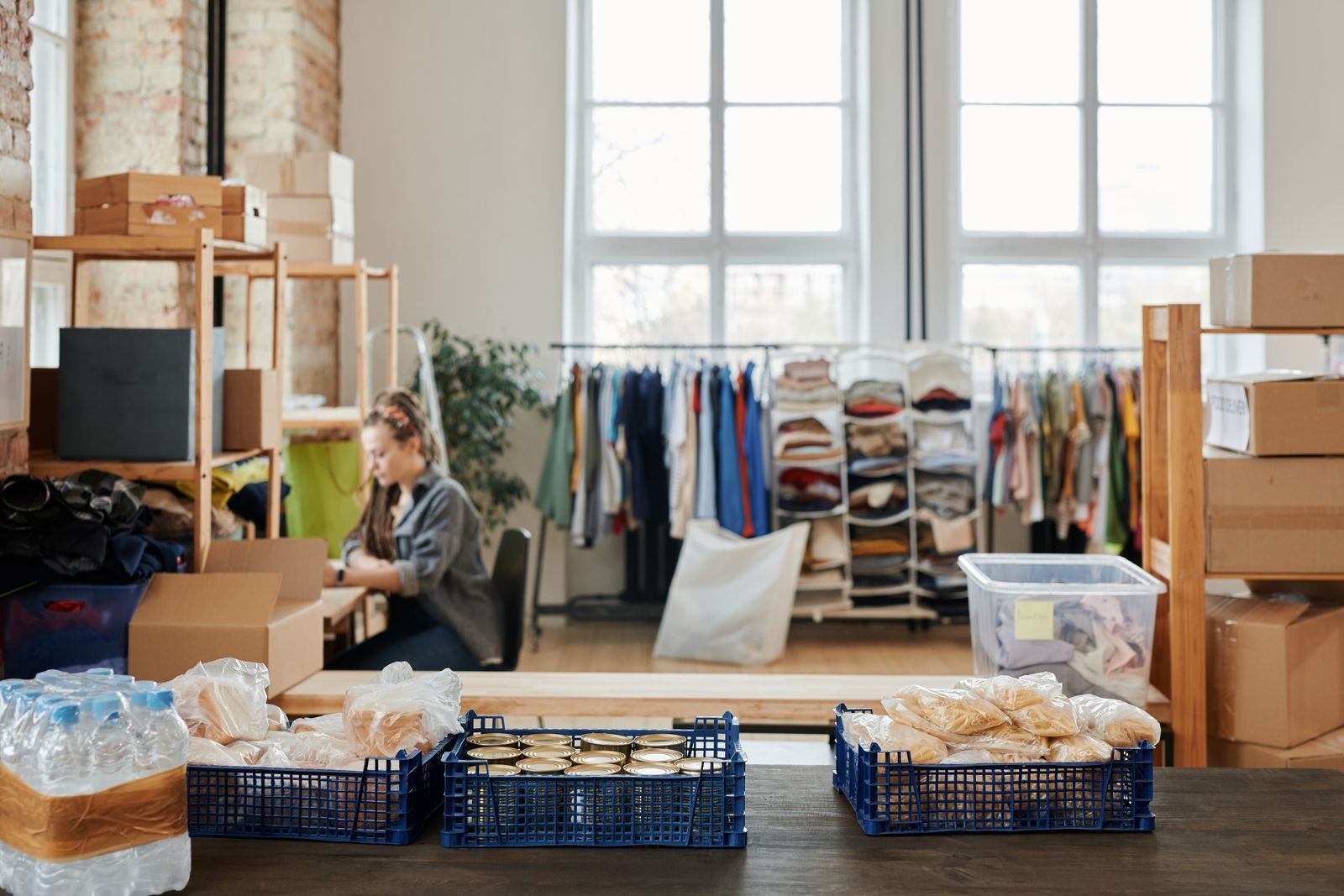 Bright workspace with clothing racks and organized bins