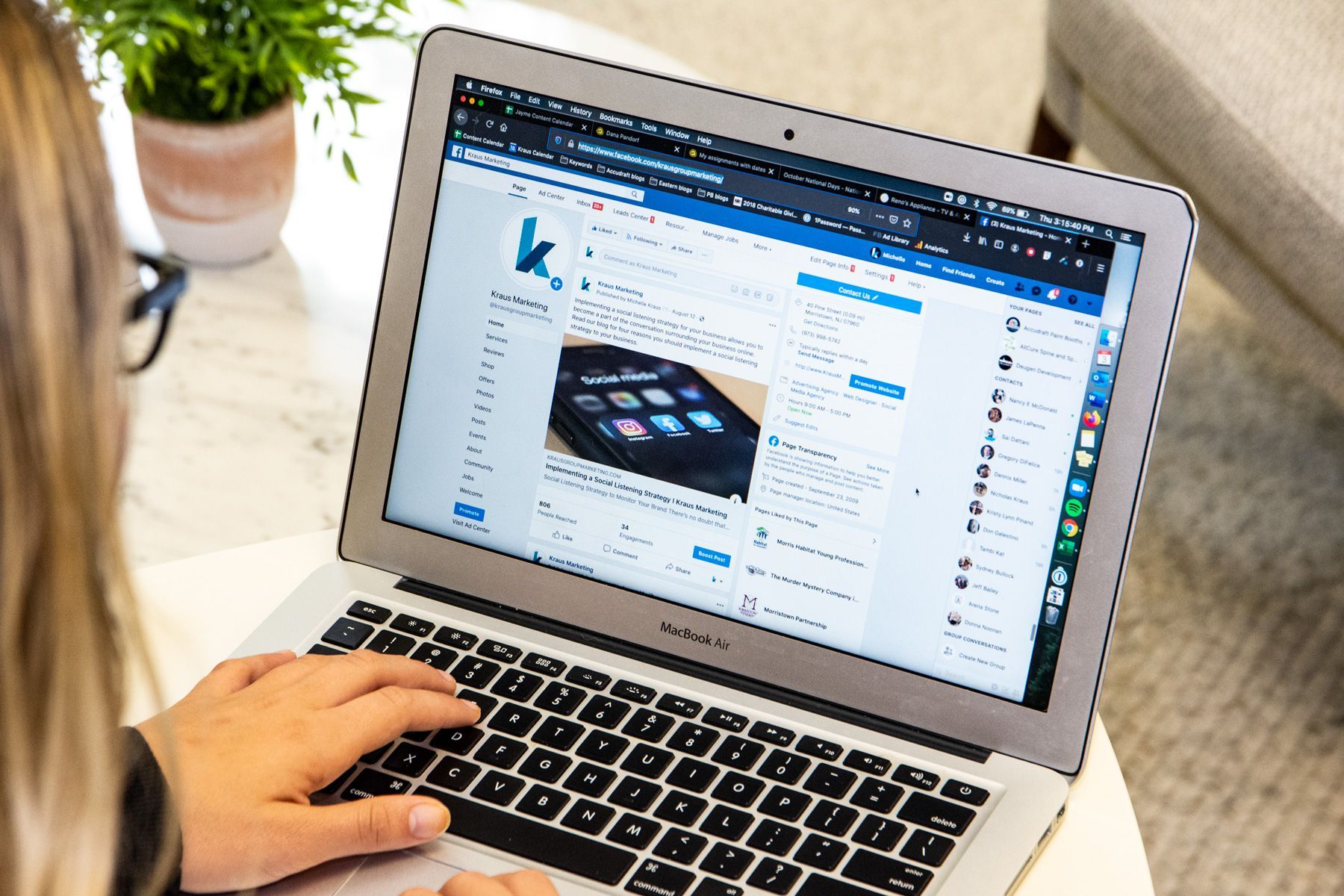 Person using a laptop, on a social media profile, with a plant and couch in the background.