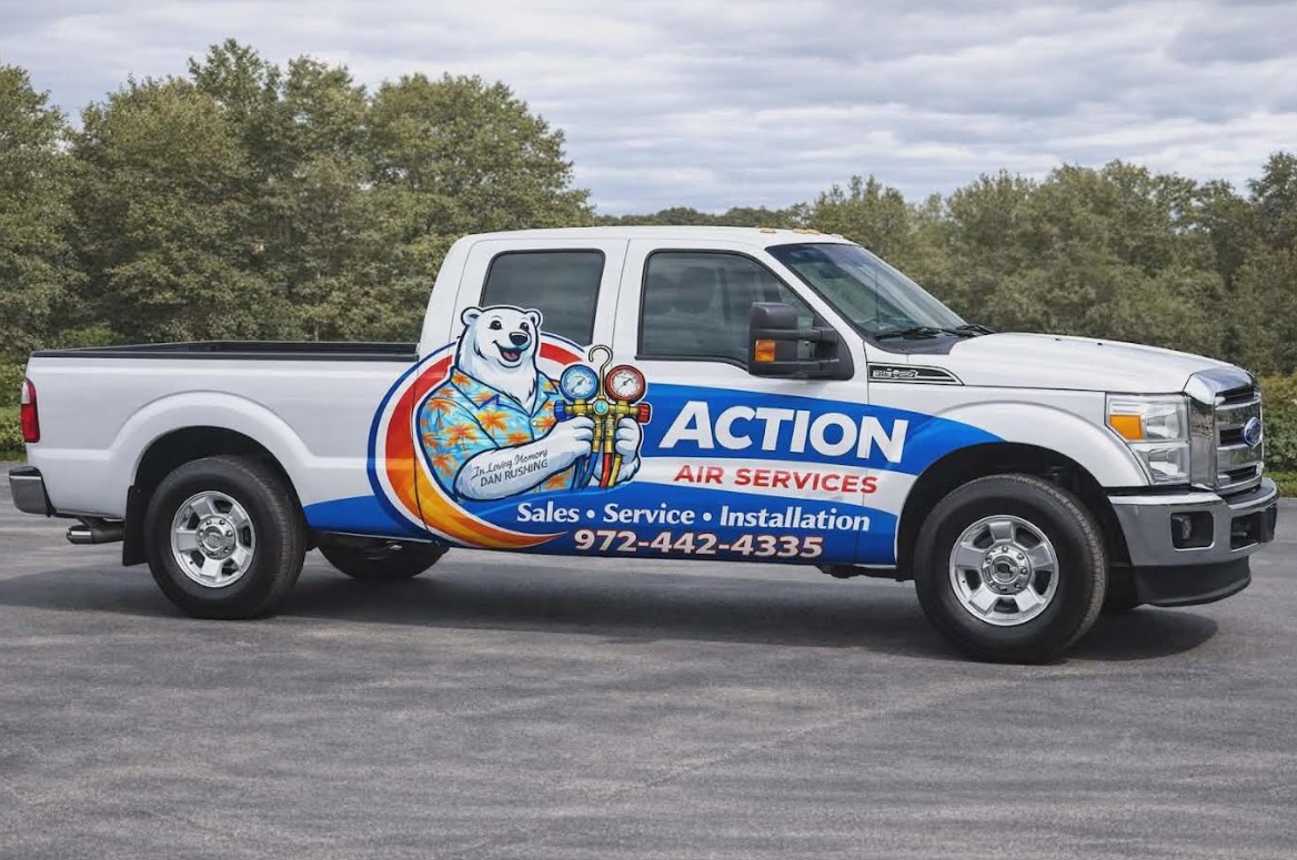 White pickup truck with “Action Air Service” logo and colorful mascot on the side, parked outdoors