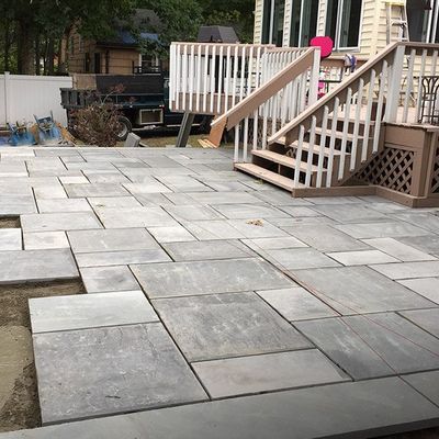 A patio with stairs leading up to a house