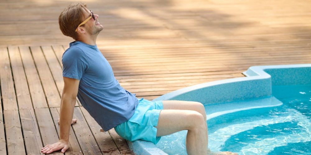 Person relaxing in a swimming pool on a sunny day