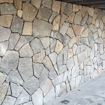 A large stone wall with a lot of different colored rocks