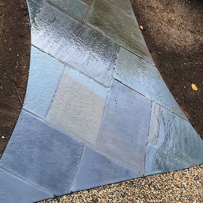 A close up of a tile floor with a diagonal pattern