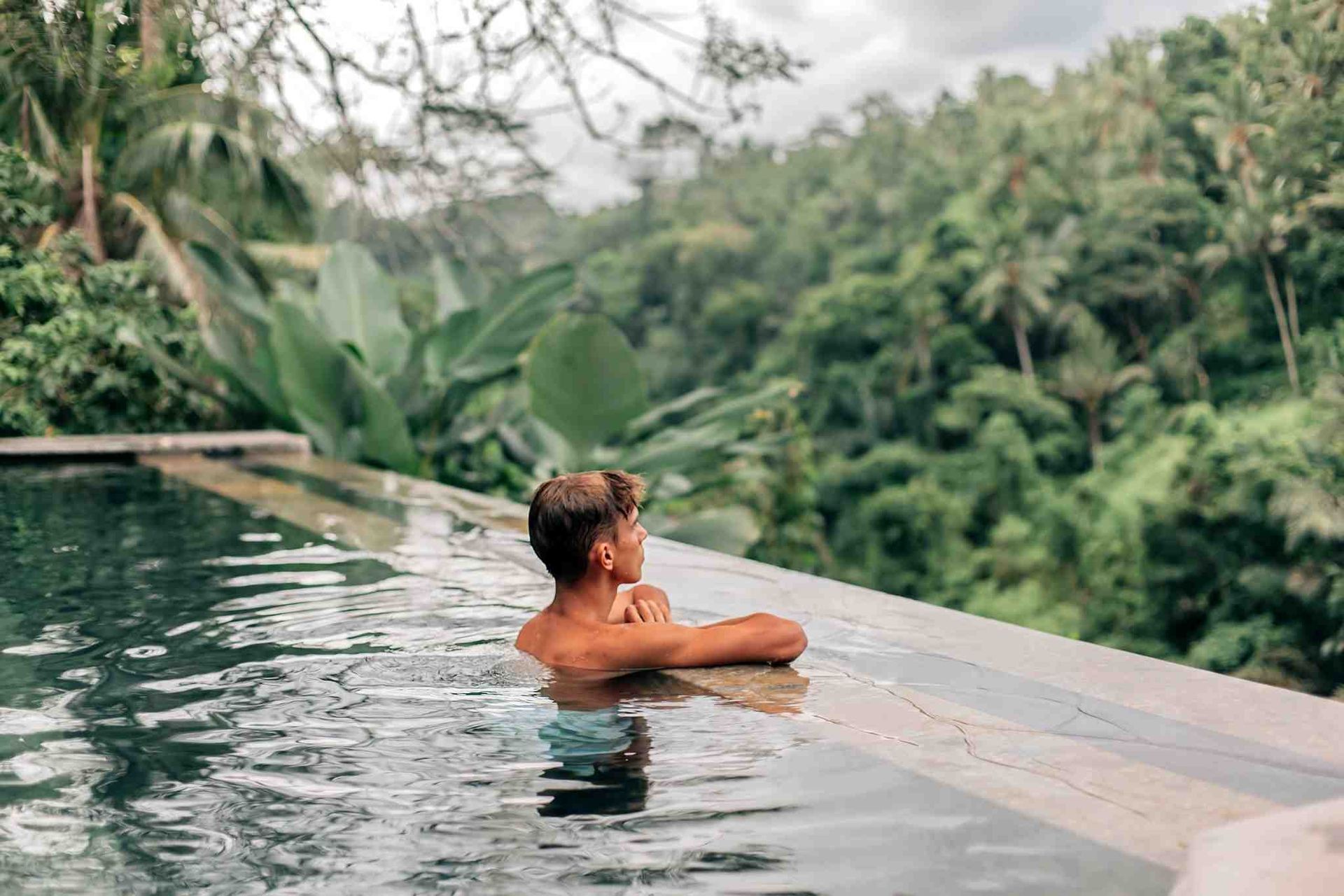 man swimming on the pool