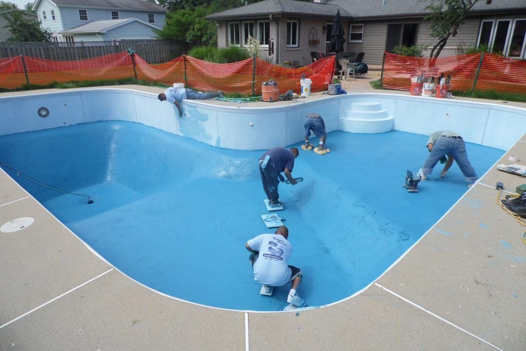 Pool contractors patching pool flooring