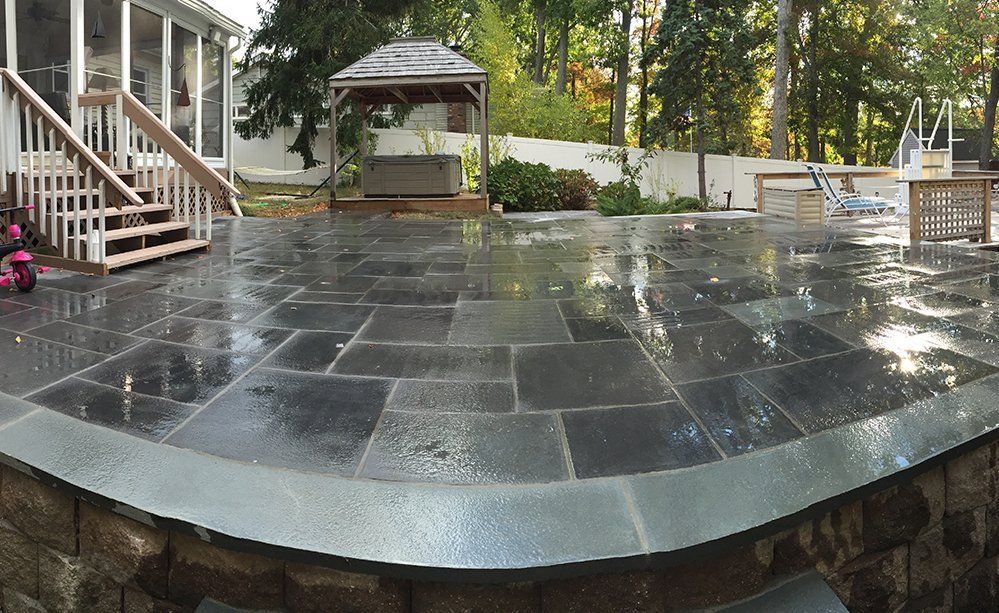 A patio with a gazebo and stairs in the background