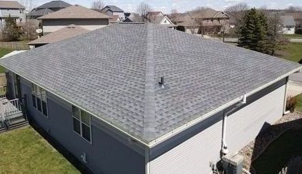 An aerial view of a house with a new roof.