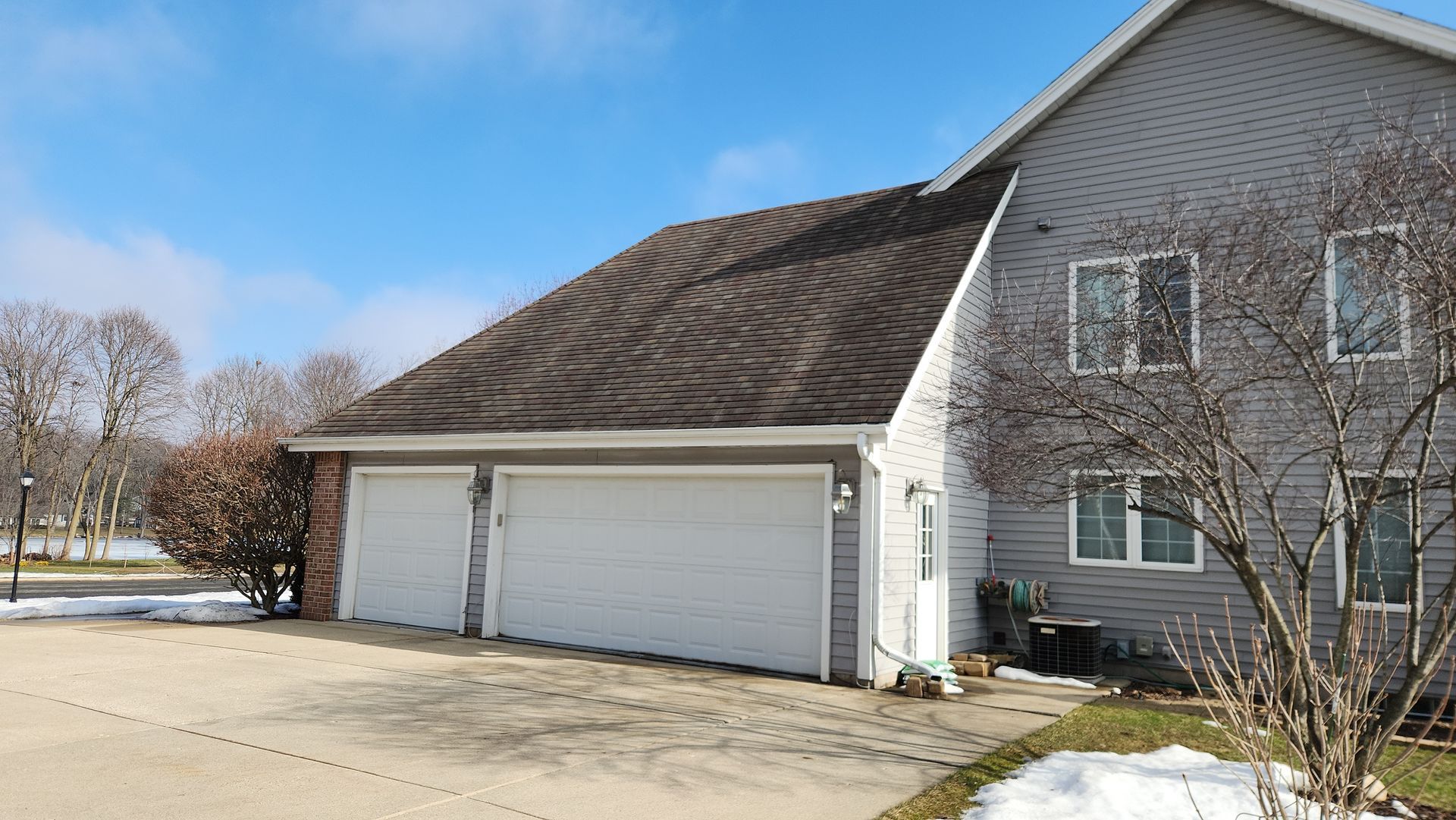 A house with a garage and a driveway in front of it