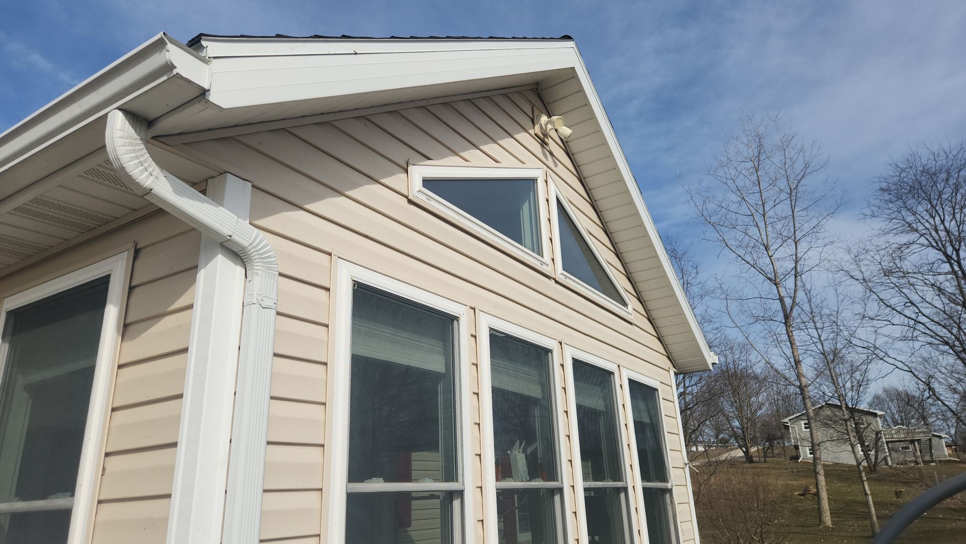 A house with a lot of windows and a gutter on the side