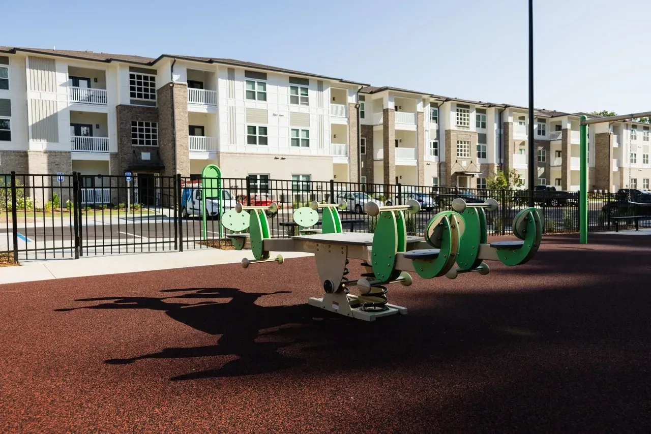 Outdoor communal fitness equipment in an apartment complex courtyard.