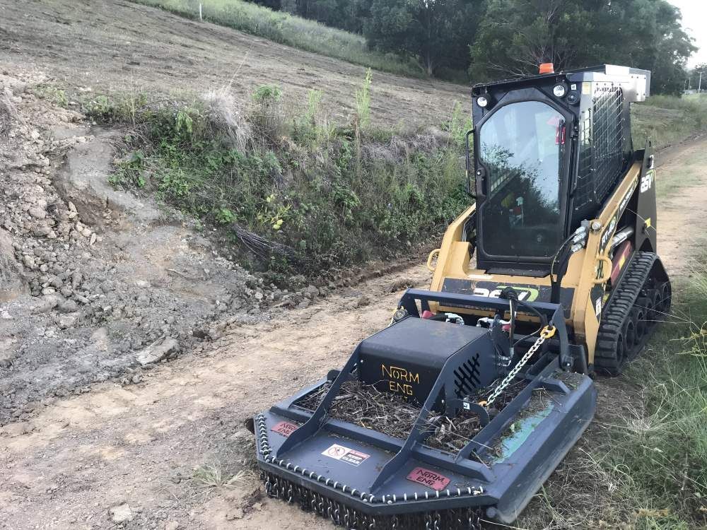 A Small Bulldozer is Sitting on the Side of a Dirt Road — Eggins Earth & Road in Wardell, NSW