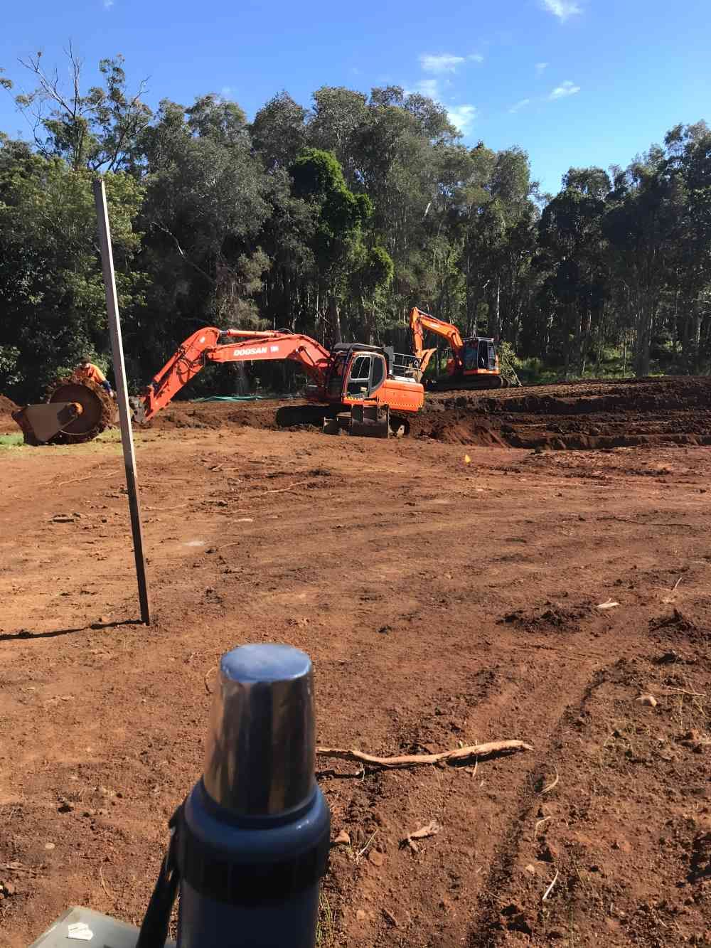 A Group of Construction Vehicles Are Working on a Dirt Field — Eggins Earth & Road in Lismore, NSW