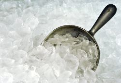 A scoop of ice is sitting on top of a pile of ice. A scoop of ice is sitting on top of a pile of ice.