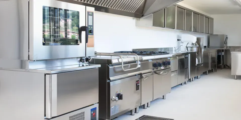 A kitchen with stainless steel appliances and a stove.