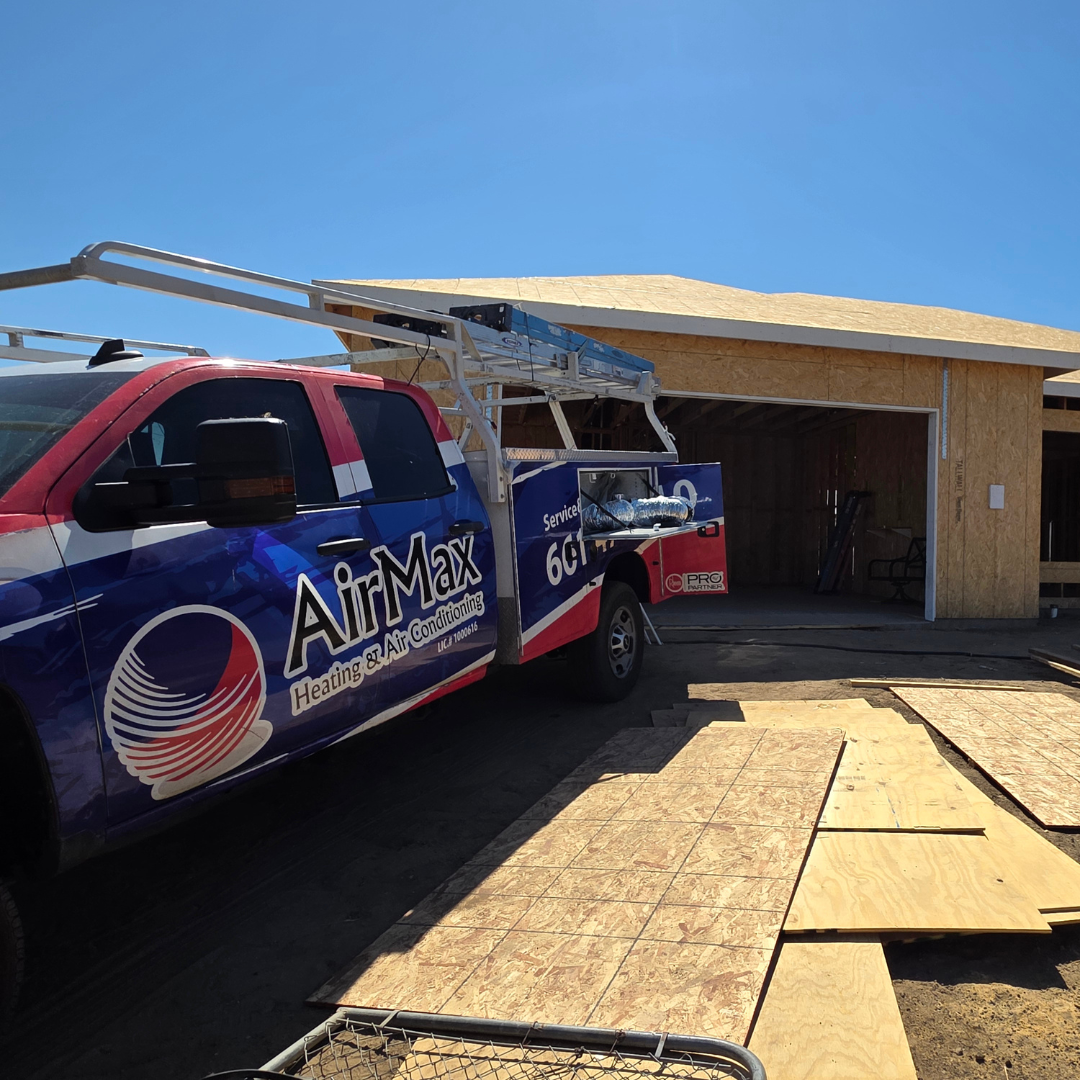 Air Van truck parked beside a garage under construction on a sunny day