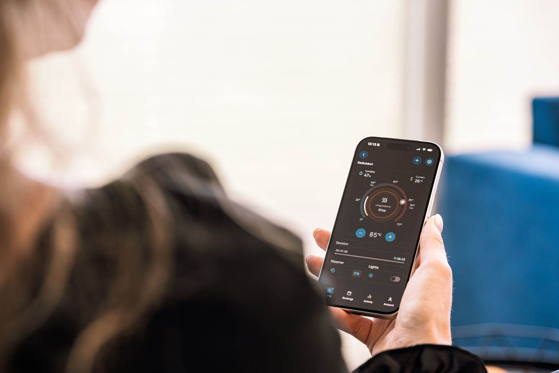 Person holding a smartphone with a music player app open on the screen