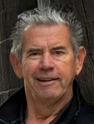 Close-up portraitbof Dr. Stadolnik against a dark wooden background