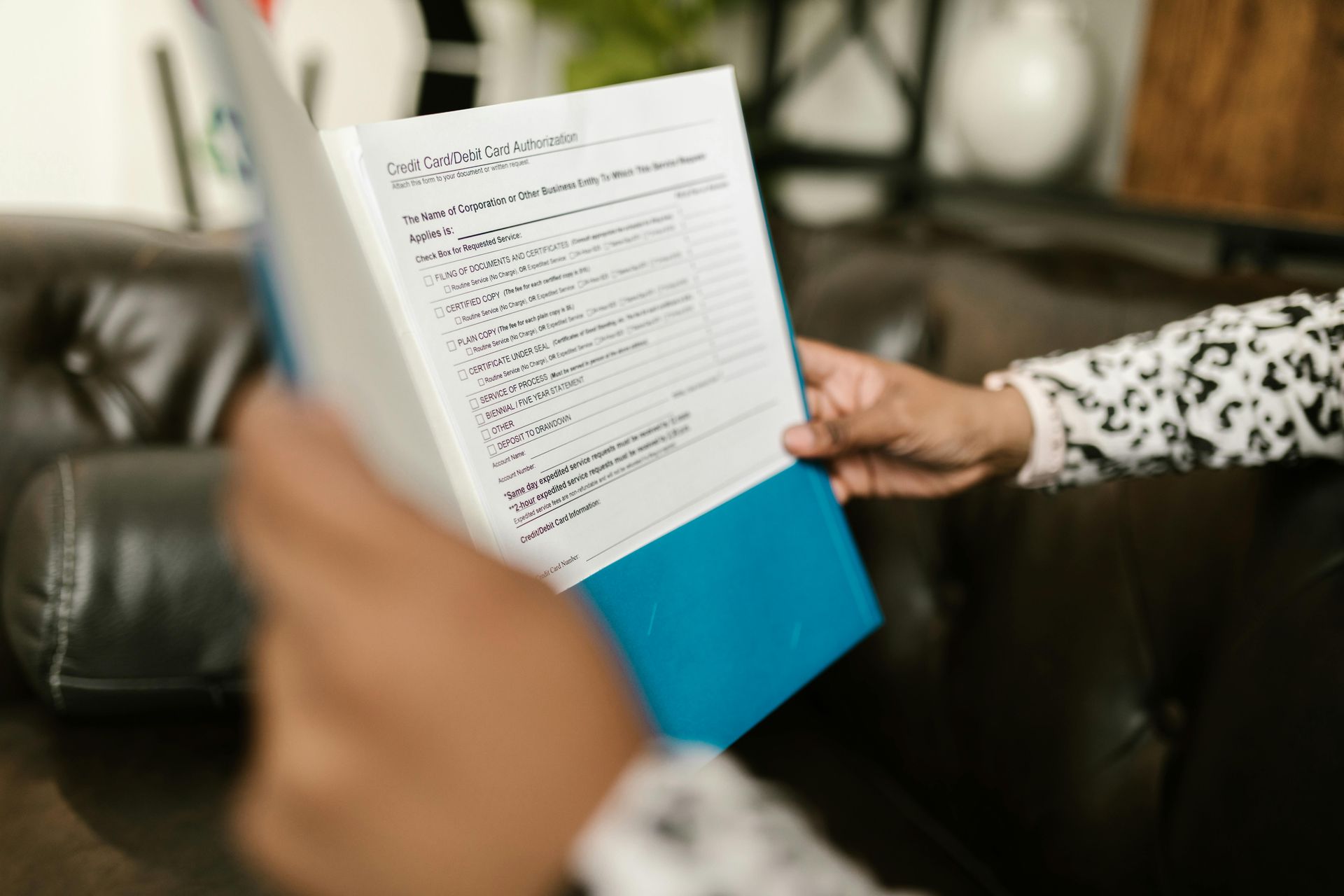 A person is holding a piece of paper in their hand.