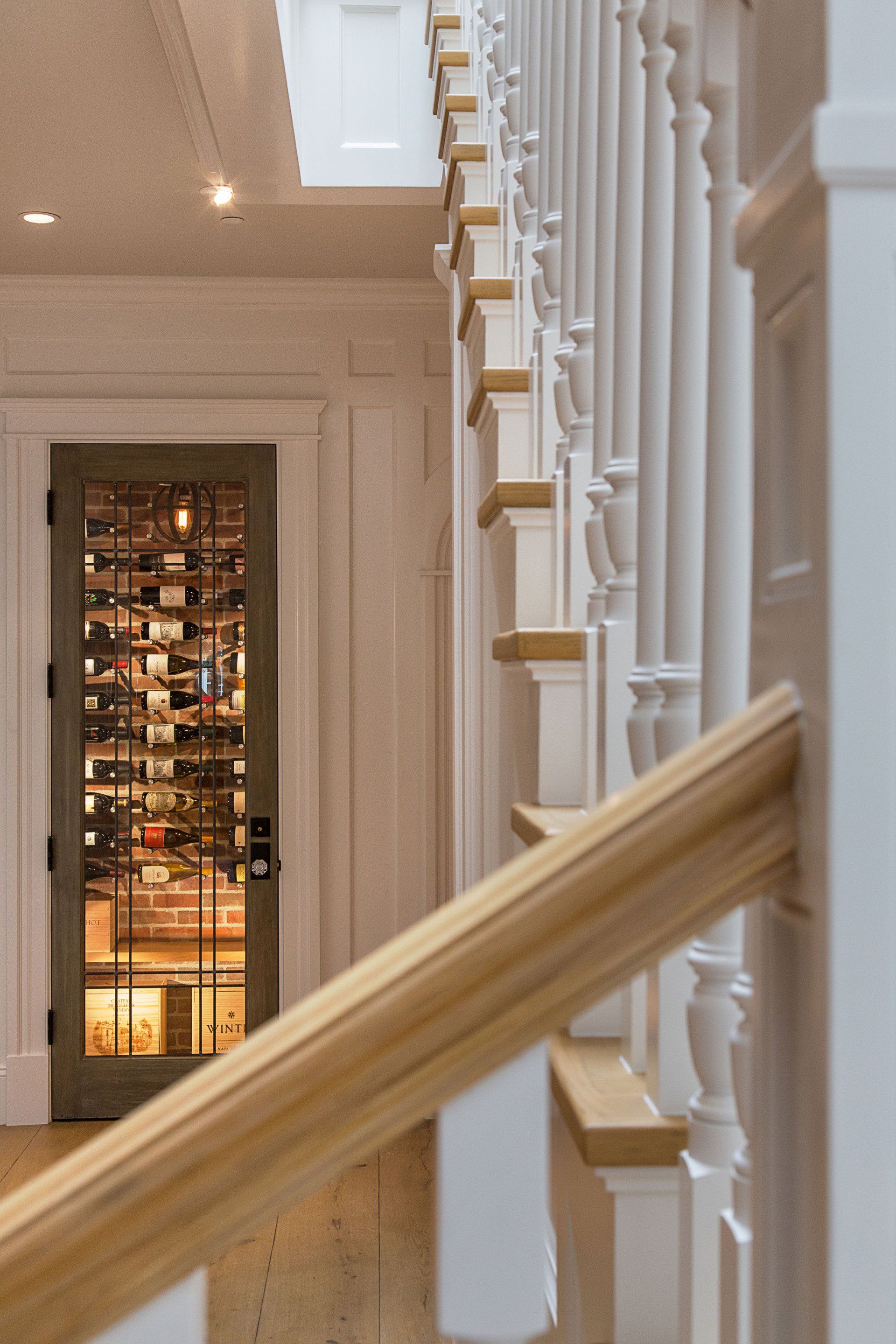 staircase and wine fridge in a Newport Beach house designed by Oatman Architects