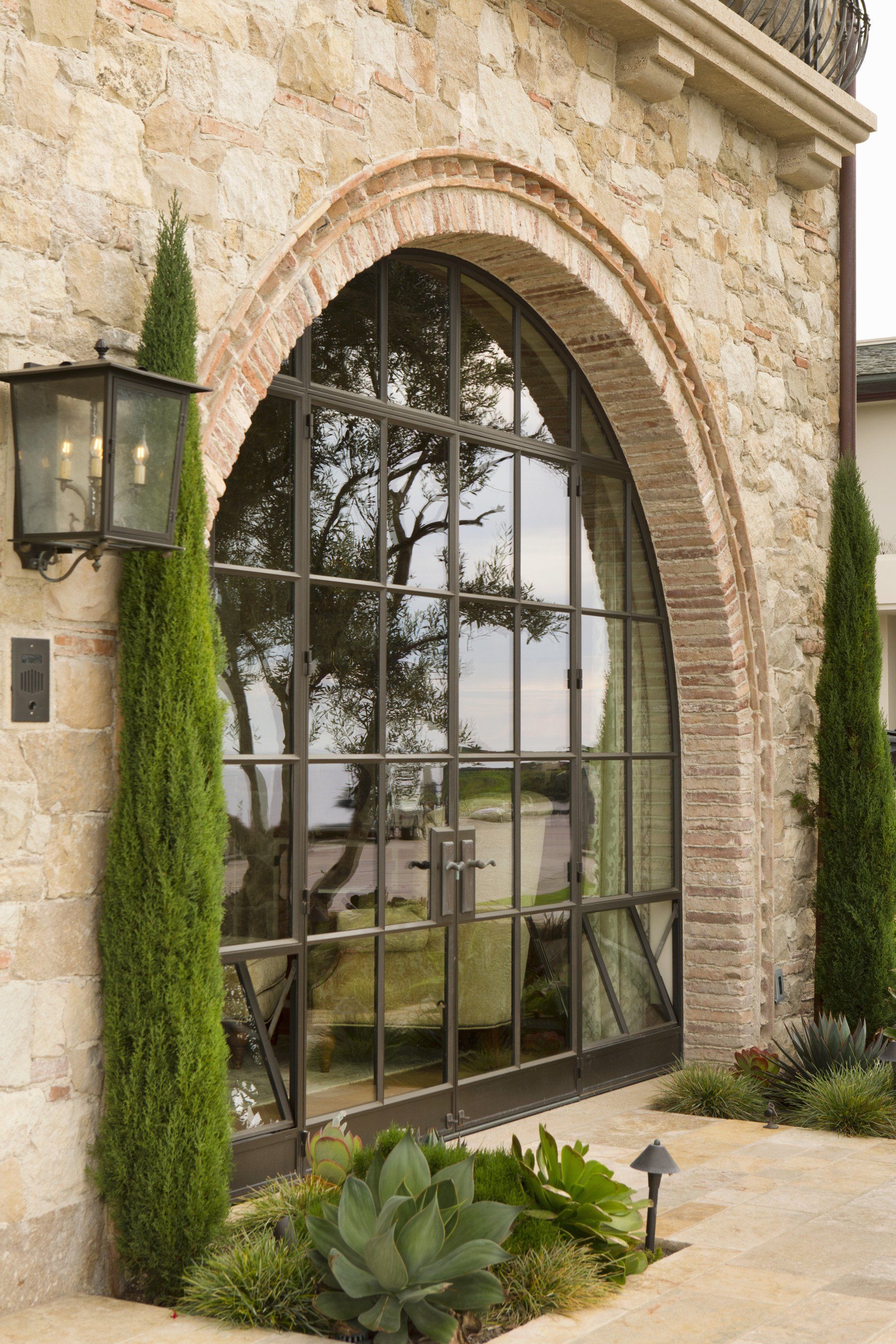 Exterior of a Tuscan stone villa in Corona Del Mar designed by Oatman Architects