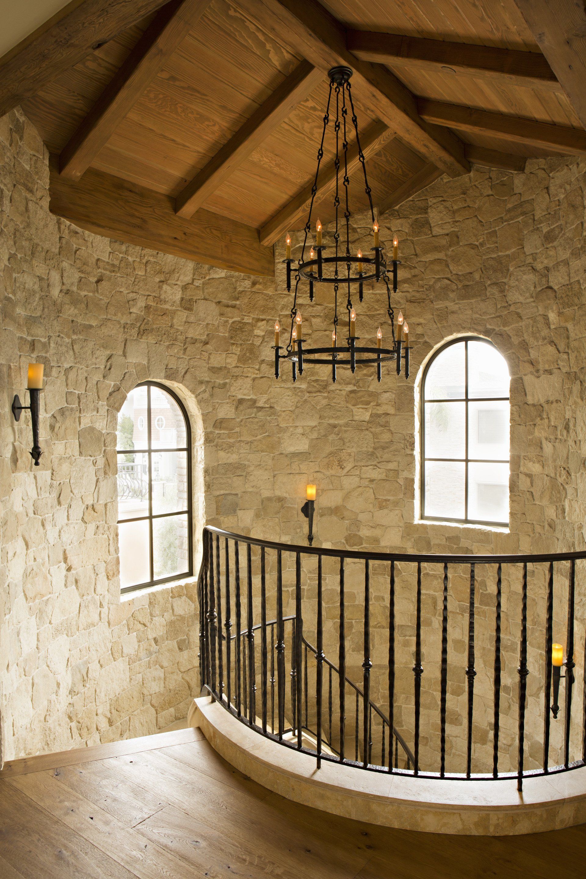 Staircase in a Tuscan stone villa in Corona Del Mar designed by Oatman Architects