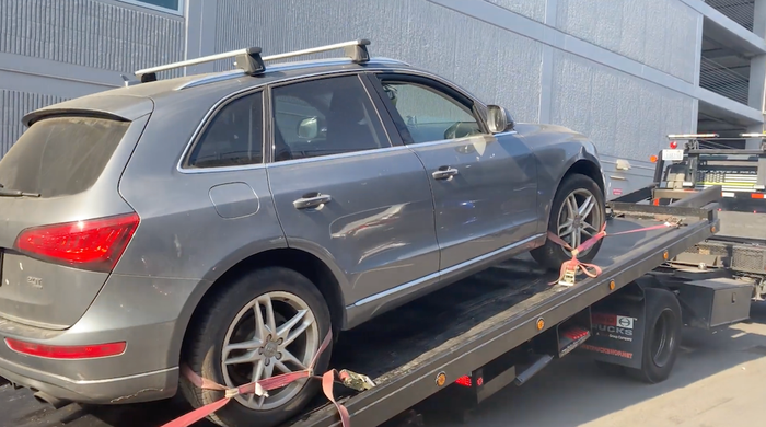 suv being loaded onto a flatbed tow truck