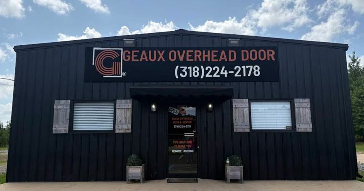 Exterior of Geaux Overhead Door building; black with logo, phone number, and windows.