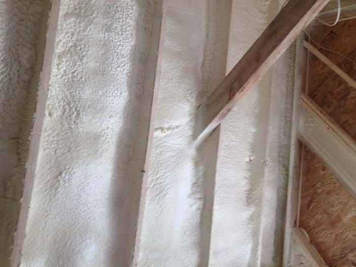 spraying foam on a wooden area