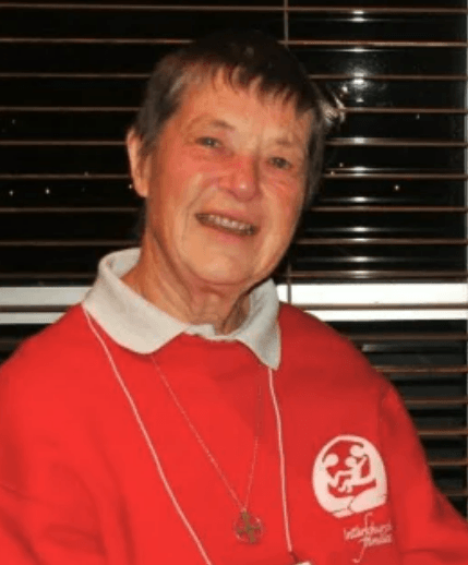 Picture of Ruth Reardon smiling and wearing an Association of Interchurch Family Sweatshirt