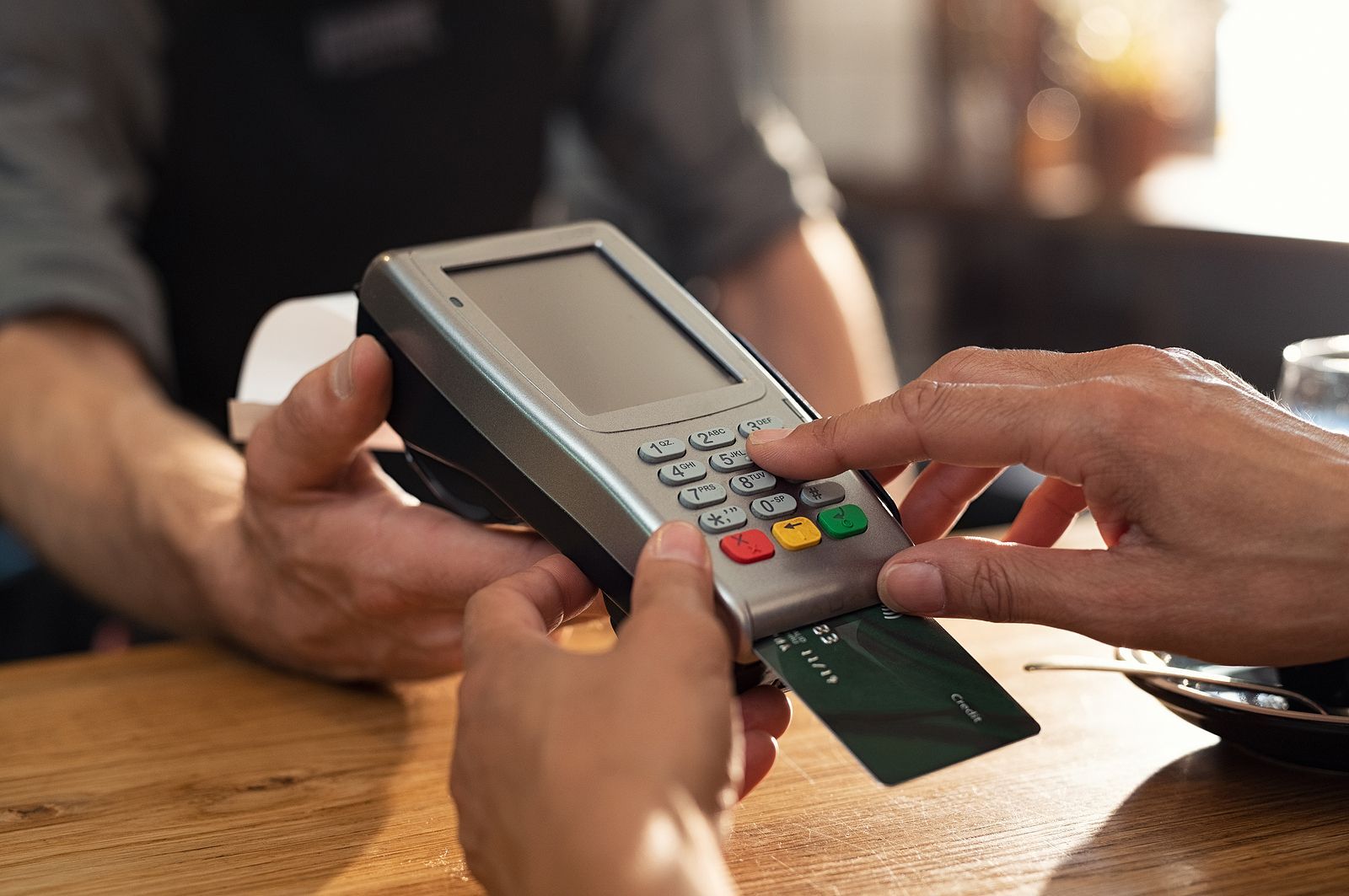 A person is using a credit card to pay for something.