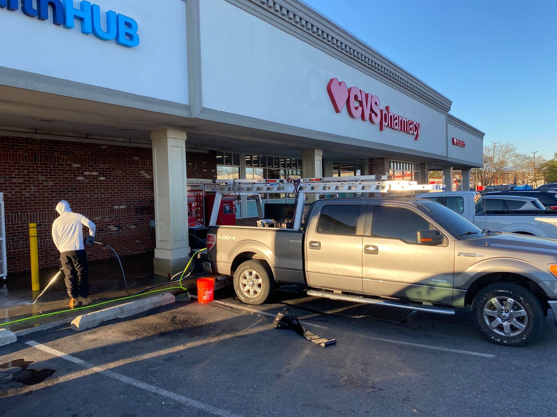 A pickup truck is parked in front of a store.