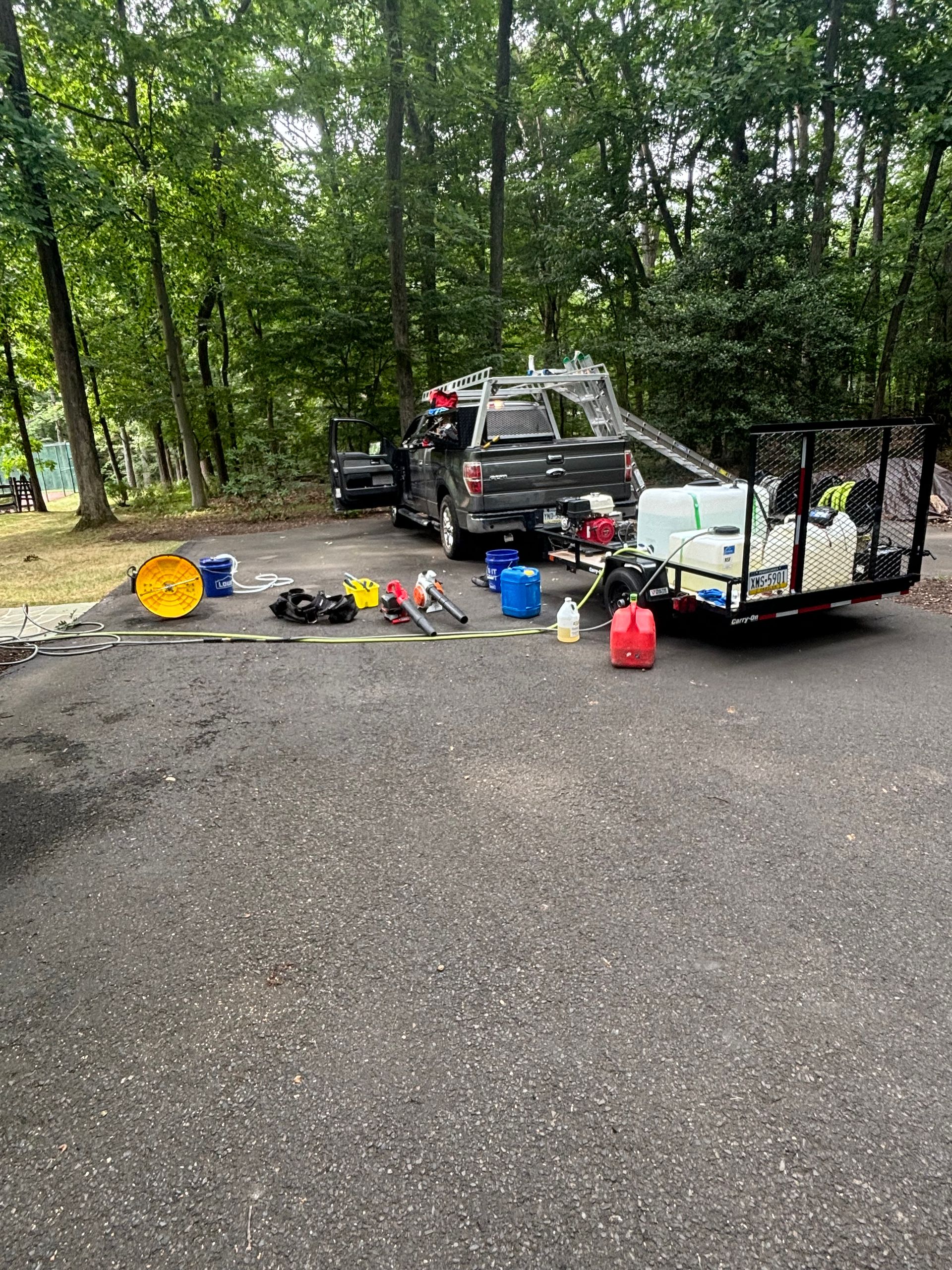 A truck and trailer are parked on the side of the road.
