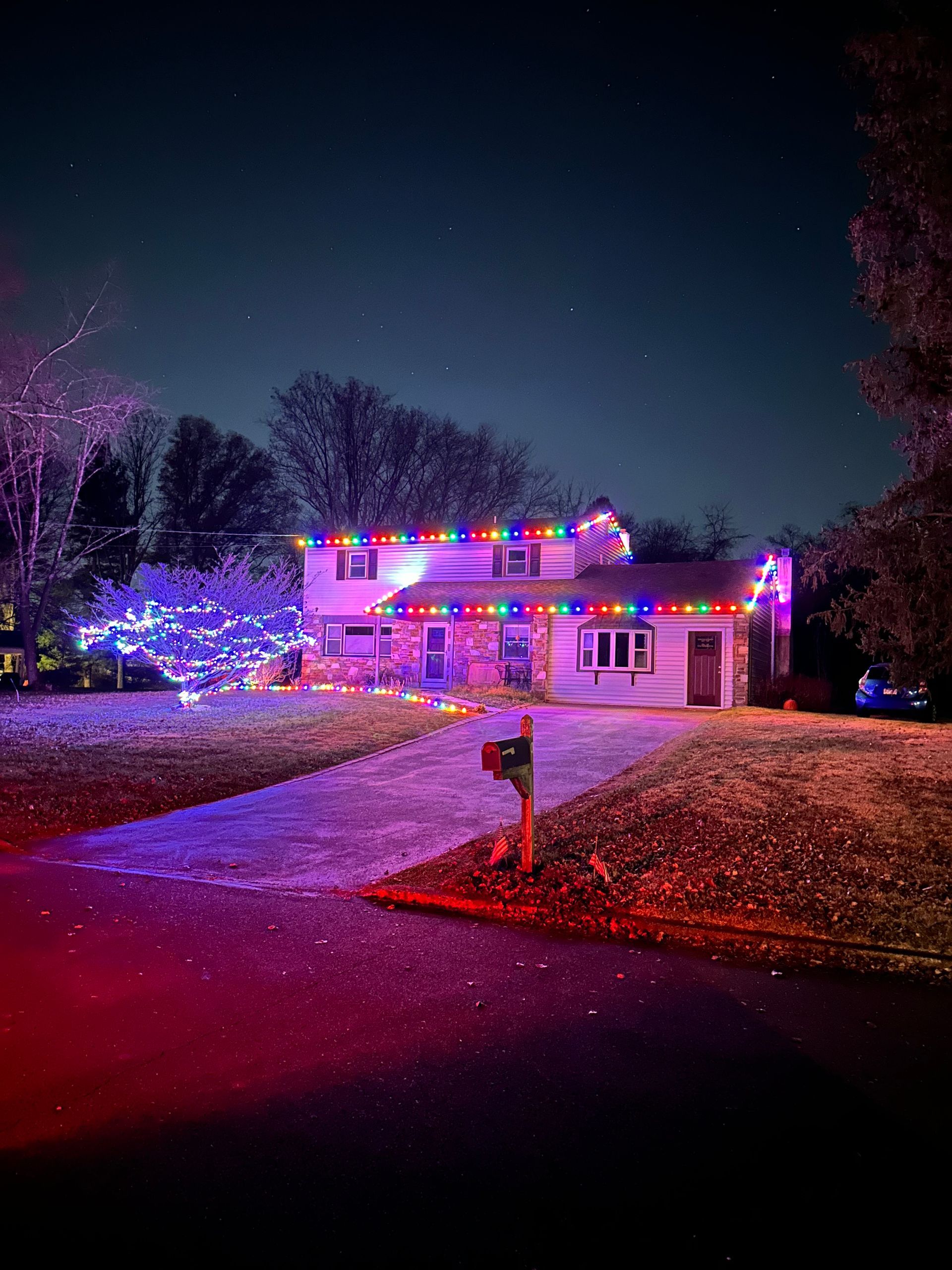 A house is decorated with christmas lights at night.