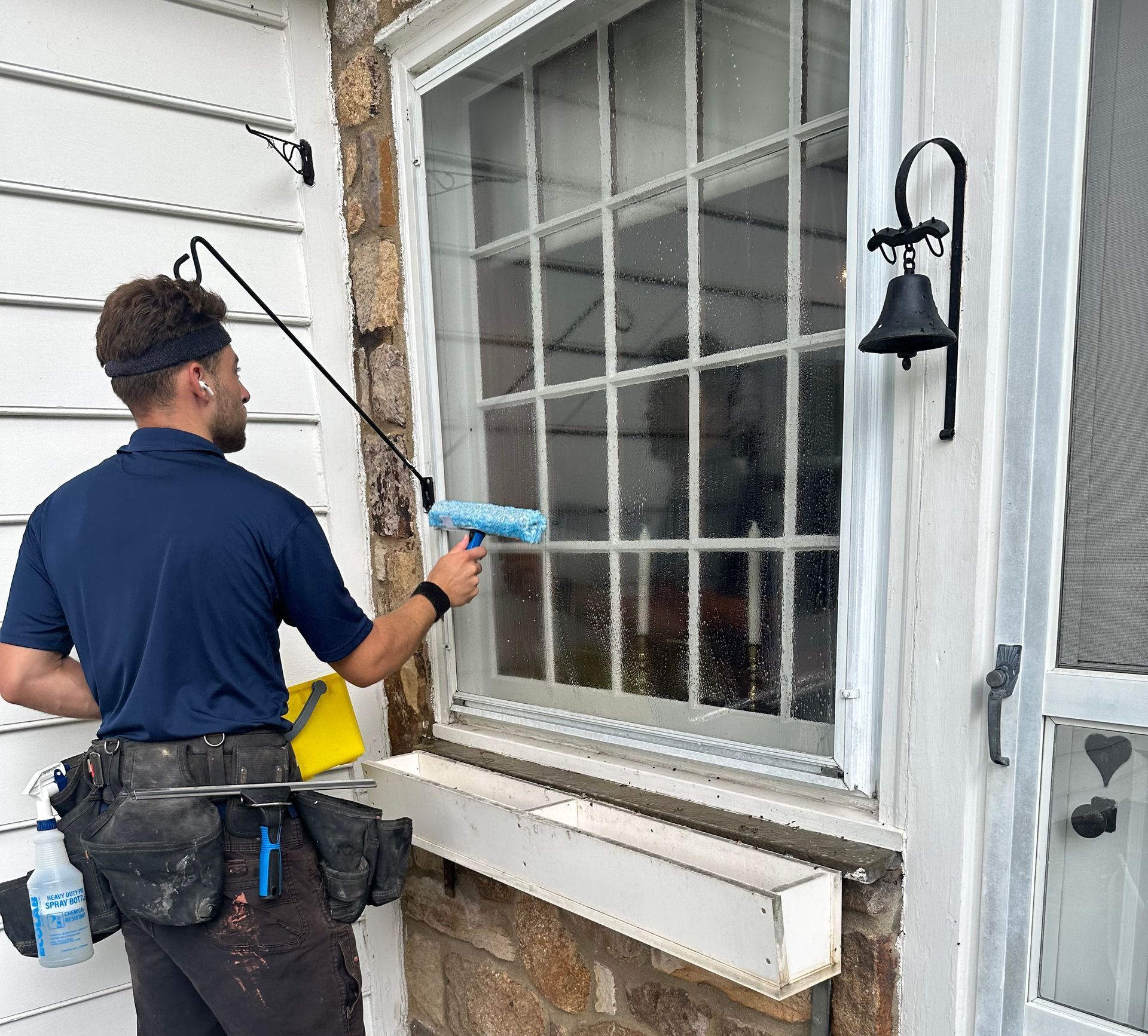 A man is cleaning a window with a squeegee