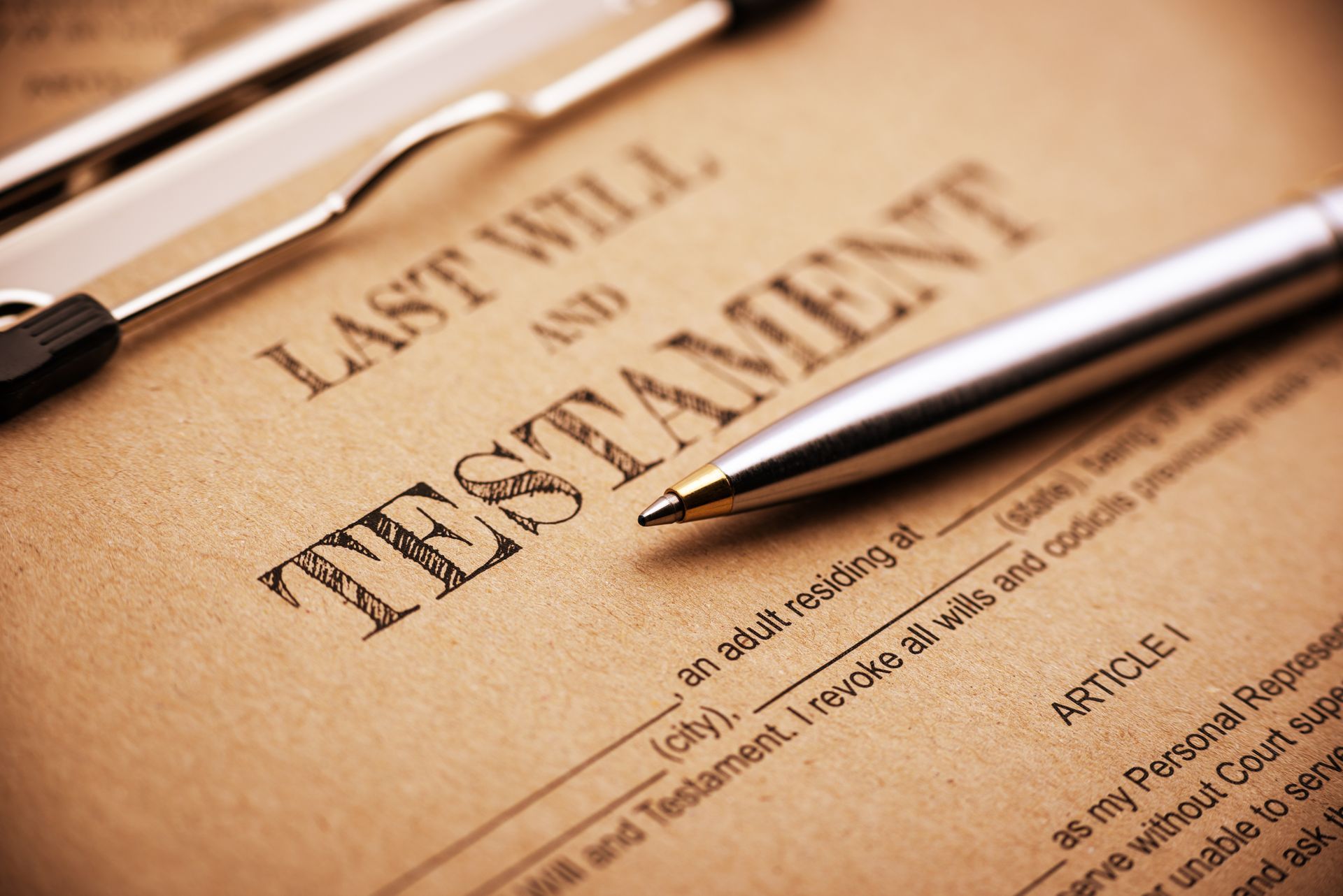 A pen is sitting on top of a last will and testament