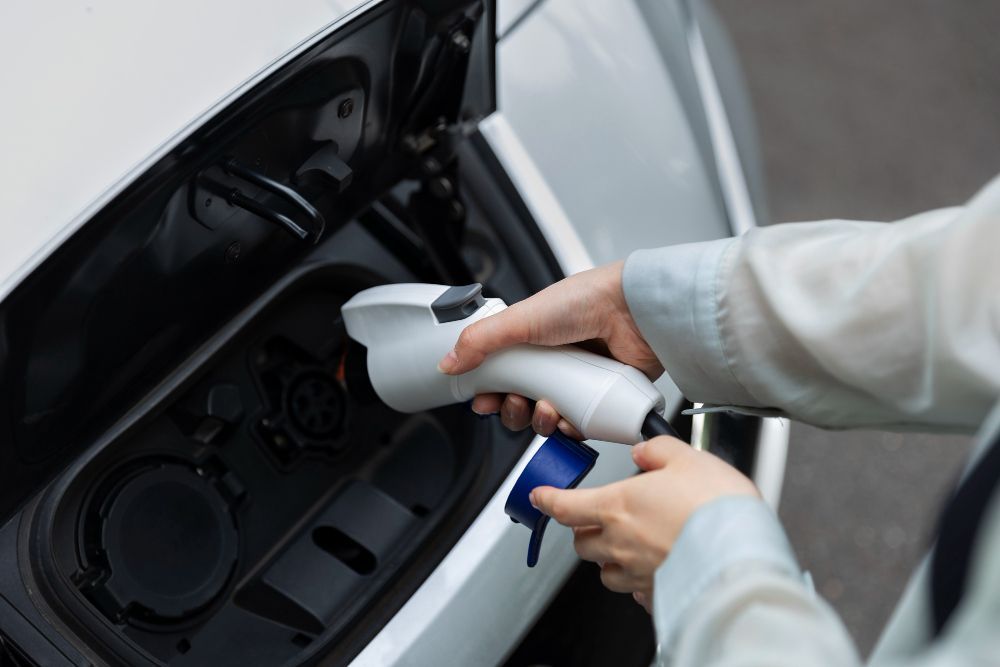A person is charging an electric car with a charger.