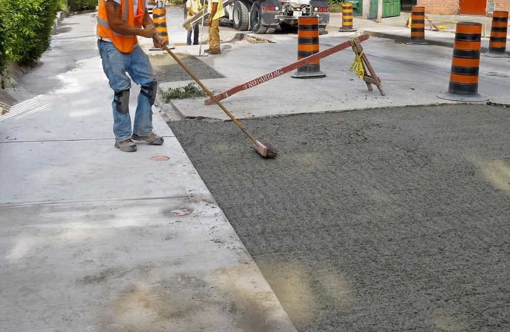 a man is sweeping the ground with a broom .