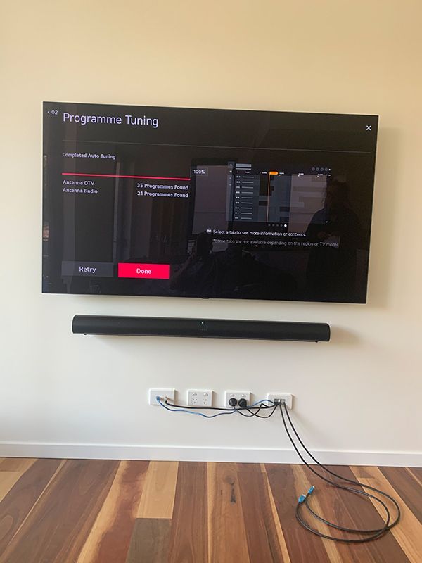 Tv Is Mounted On A Wall In A Living Room — Telecommunication Company In Gungahlin, ACT