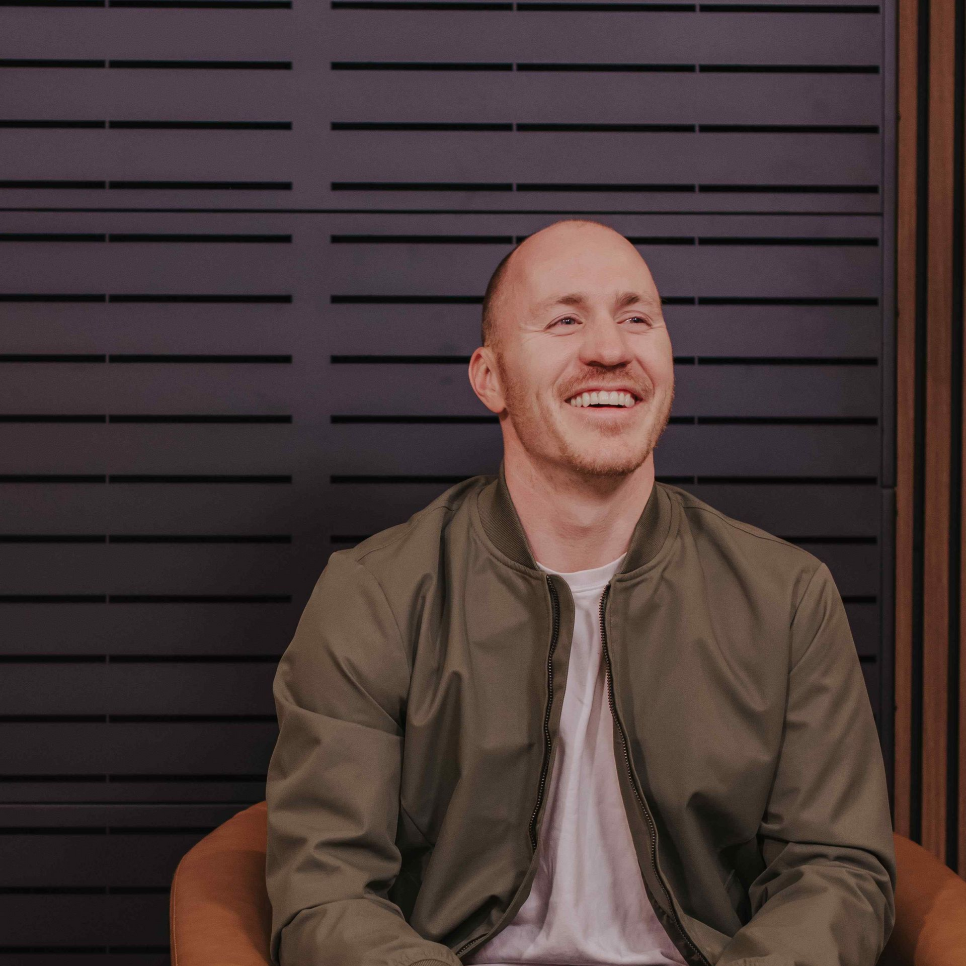 Career Coach Adam Broda Laughing While Sitting In Chair