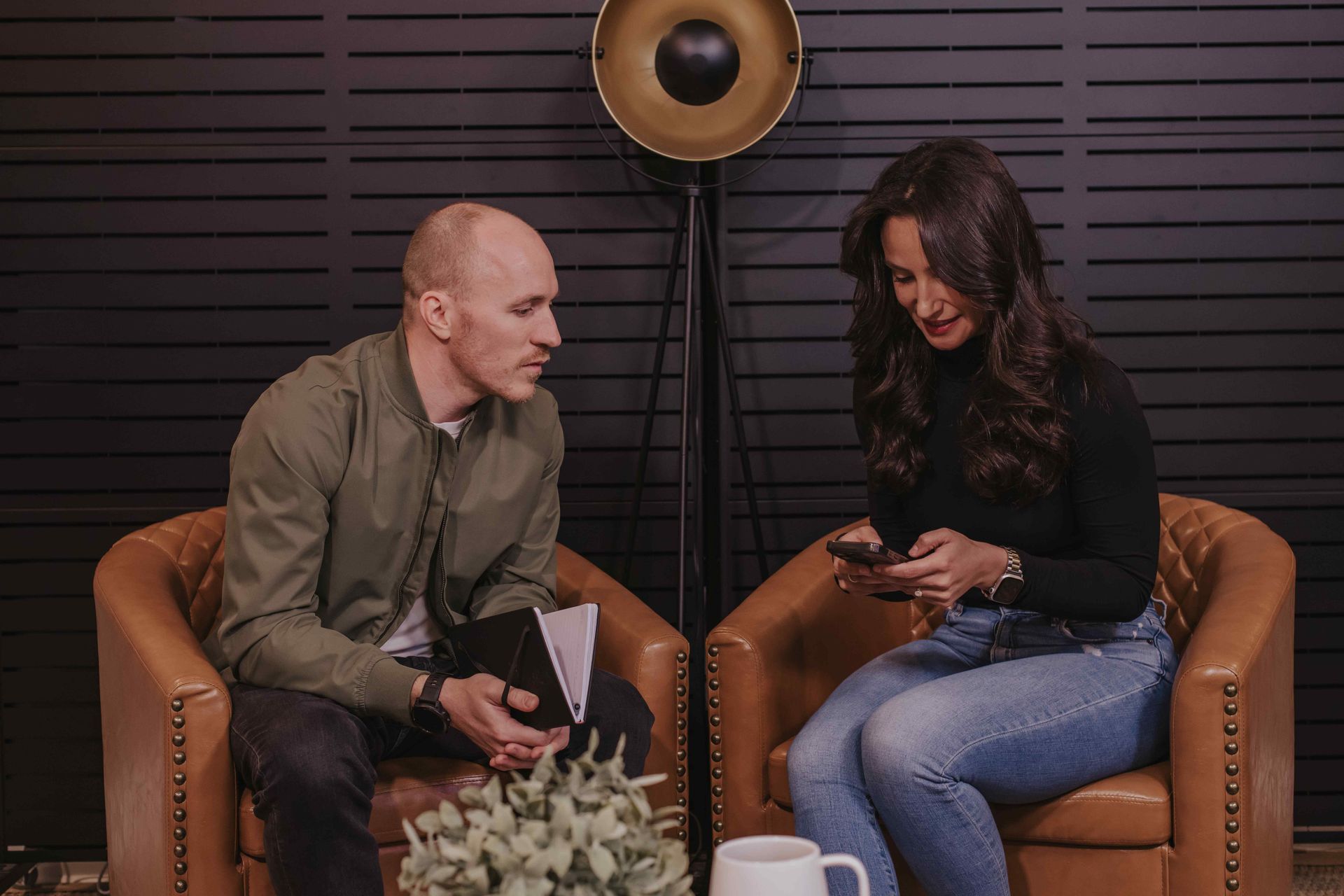 Coaches Adam Broda And Jesily Ruiz Looking At What Is On Phone
