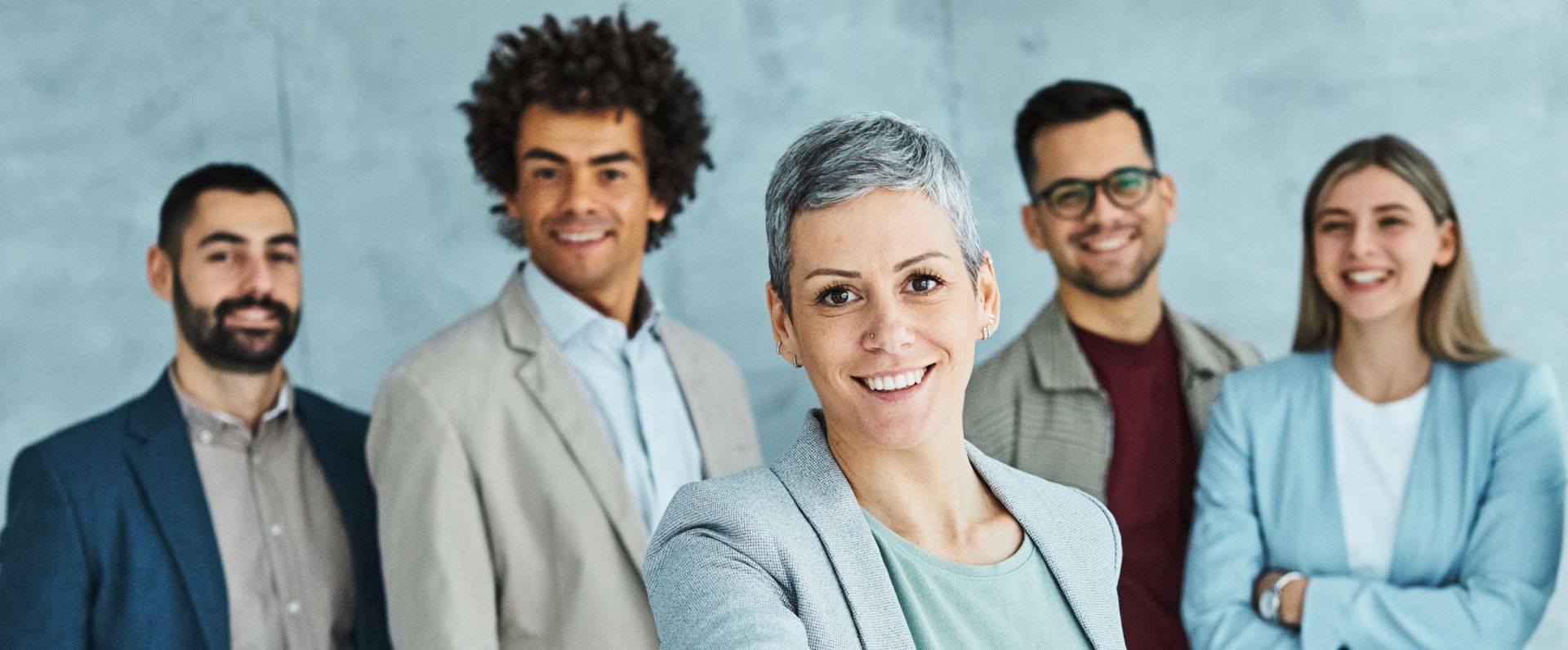 A group of business people are posing for a picture together.