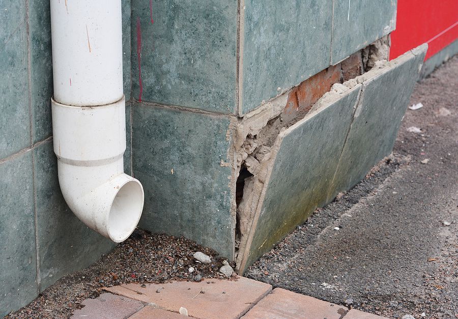a white pipe sticking out of the side of a building