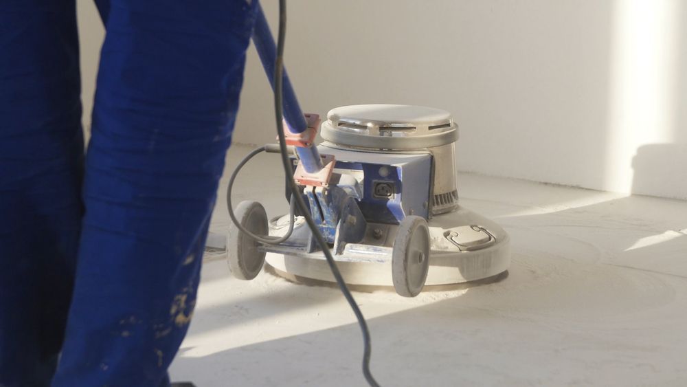 A Person Is Using A Machine To Polish The Floor — Super Home Cleaning Services In Manunda, QLD