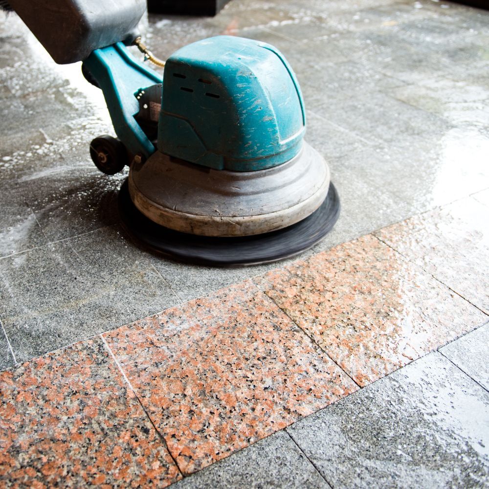 A Person Is Using A Machine To Clean A Tiled Floor — Super Home Cleaning Services In Manunda, QLD