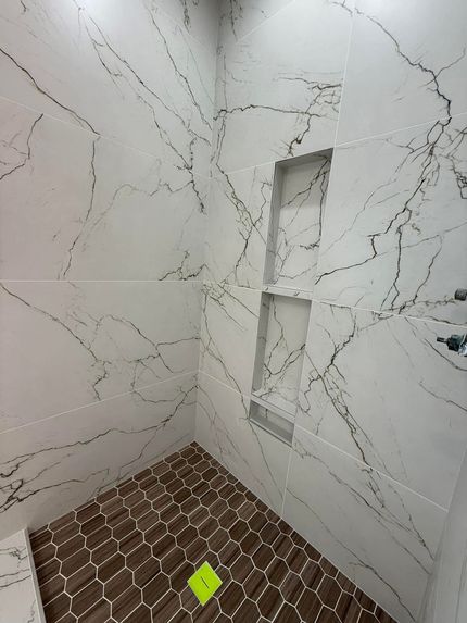 Renovating room with tools, buckets, and unfinished gray wall and floor